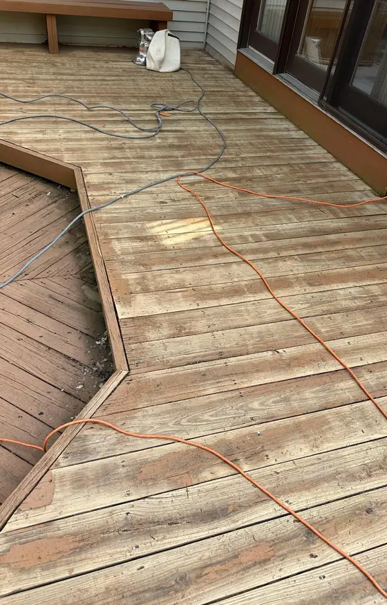 Pressure treated deck boards laid out in an angled pattern during construction