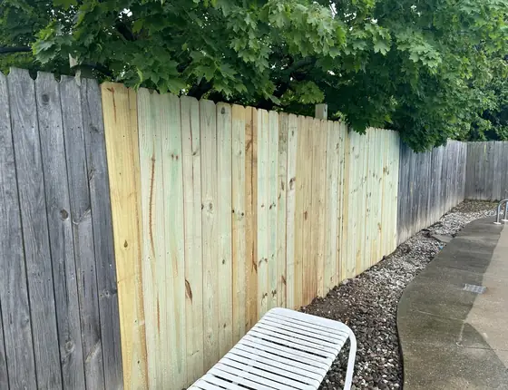 New wood fence next to an older weathered fence