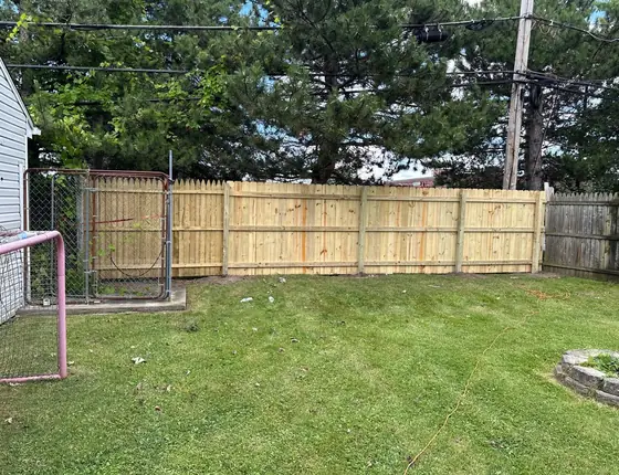 New wood privacy fence along the back of a yard