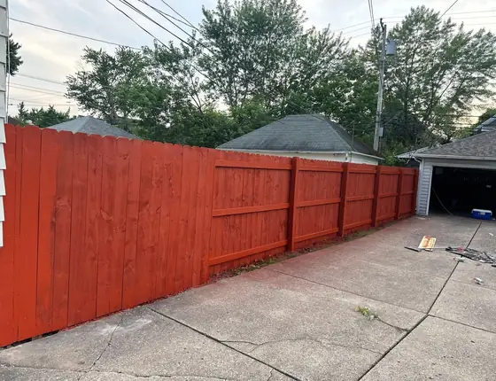 Long run of red stained wood fence