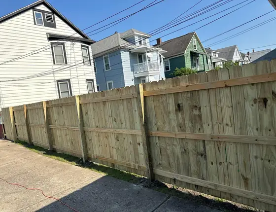Tall wood privacy fence along a residential street