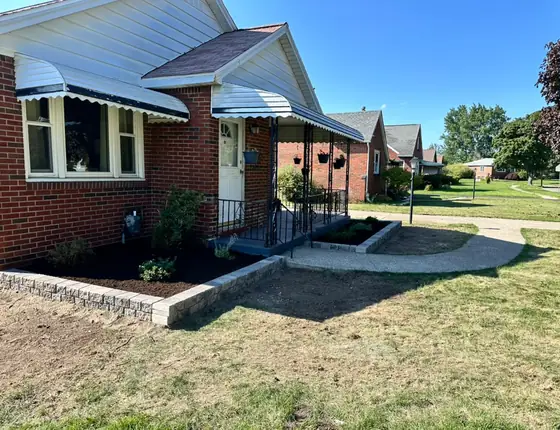Block edged front garden bed below window awnings