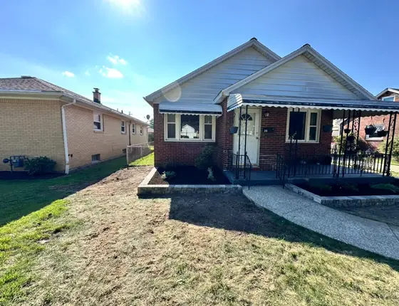 Wide view of a new block edged garden bed in a front yard