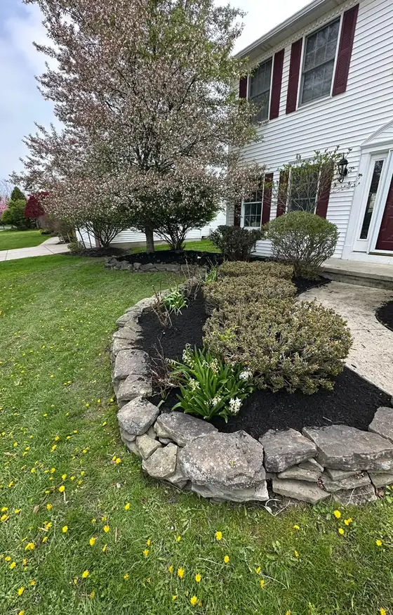 Stone edged flower bed at a home entry