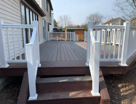 White railing and stairs leading down from a composite deck