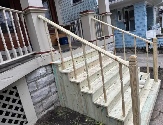 New pressure treated porch stairs with a handrail and lattice skirt
