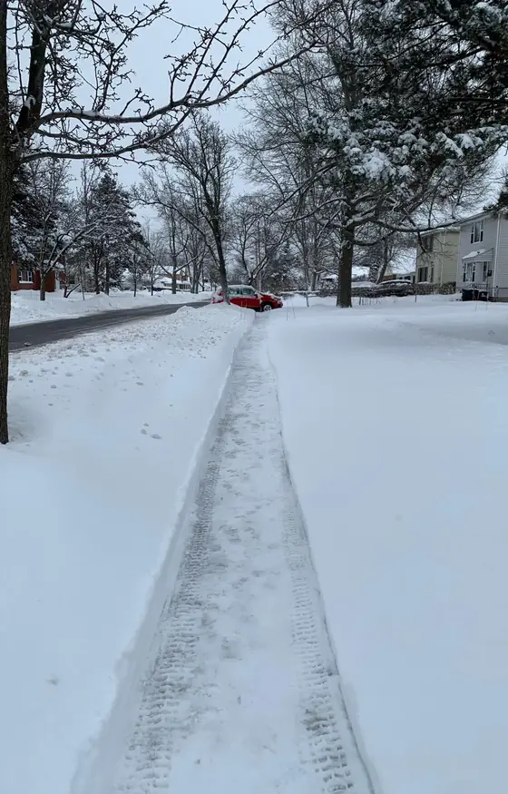 Long sidewalk cleared at a neighborhood corner